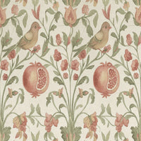 Patterned fabric with birds, pomegranates, and flowers on a light green background