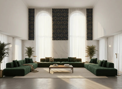 Modern living room with geometric patterned wallpaper, large green sectional sofas, and arched windows
